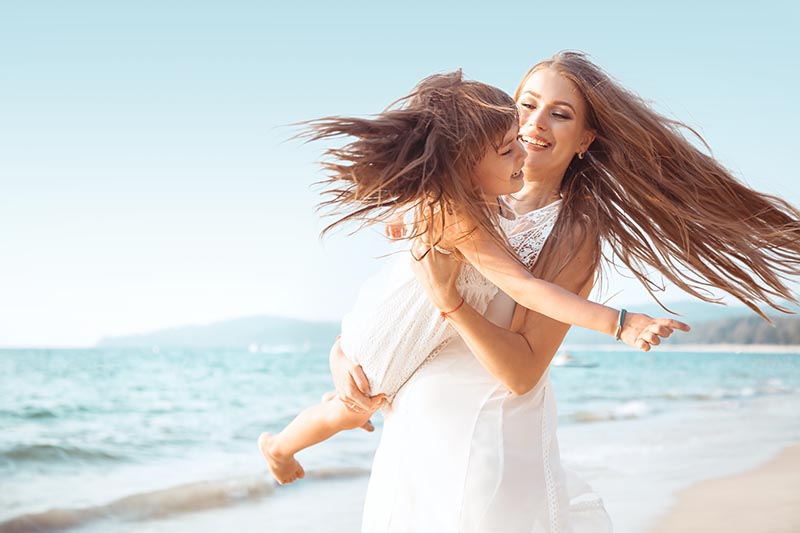 Family,walking,on,the,evening,beach,during,sunset.,child,with